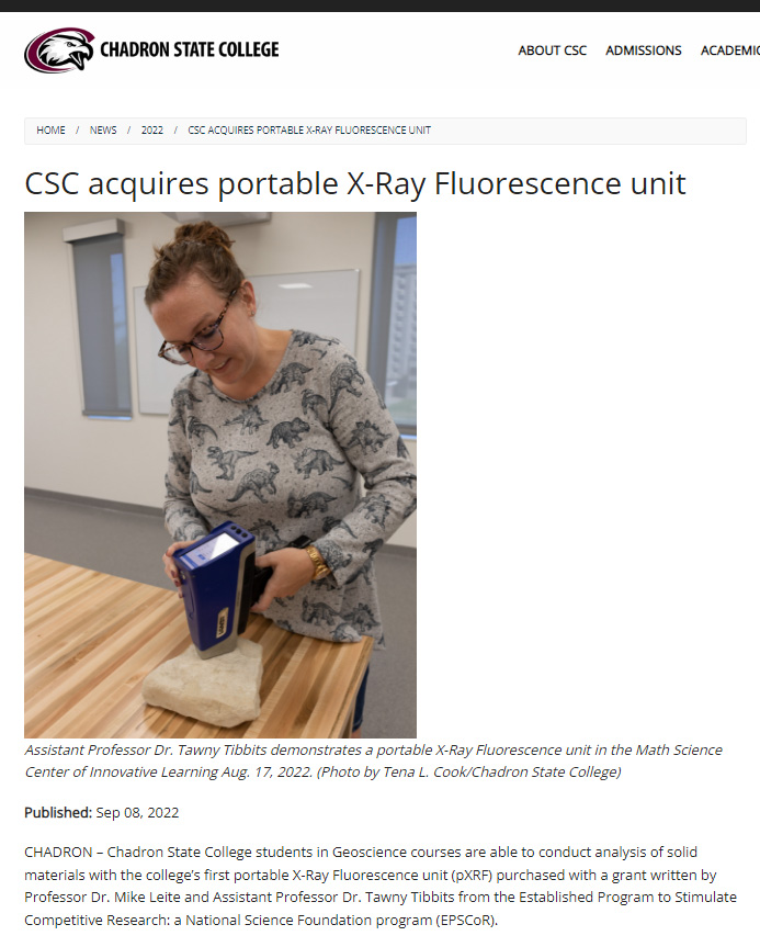 Screenshot of Chadron State College news about acquiring portable X-Ray Fluorescence (XRF) unit for teaching and research, with image of Assistant Professor Tawny Tibbits operating the device to study a rock sample.