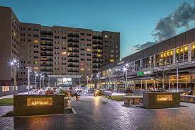 Evening view of the Capitol Entertainment District with brightly lit shops and restaurants .