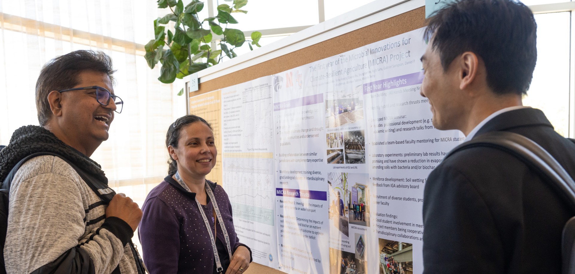 three individuals standing in front of a research board