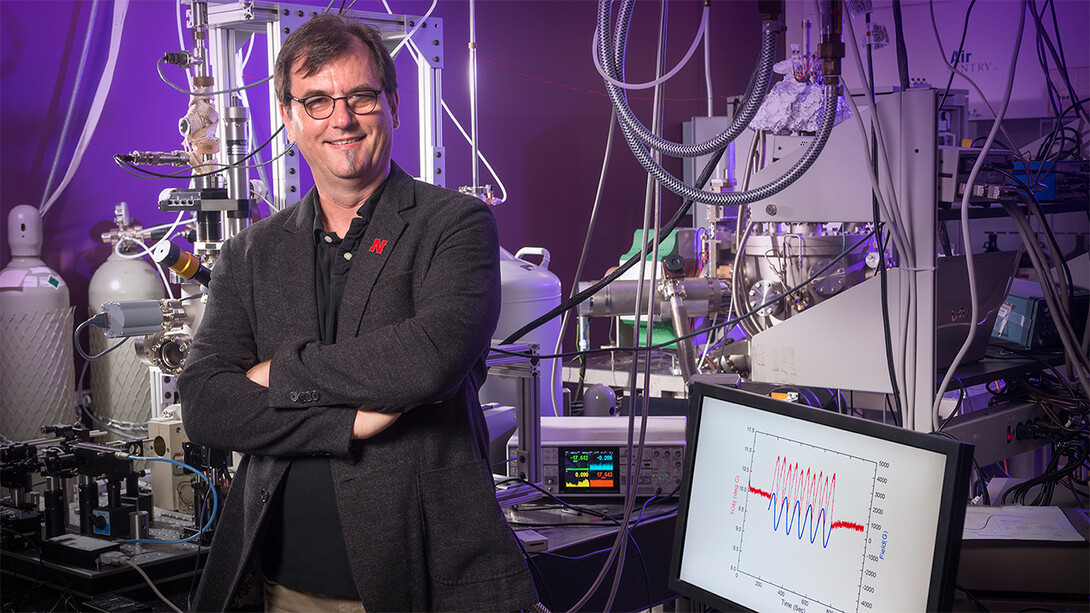 Christian Binek stands in a lab with equipment