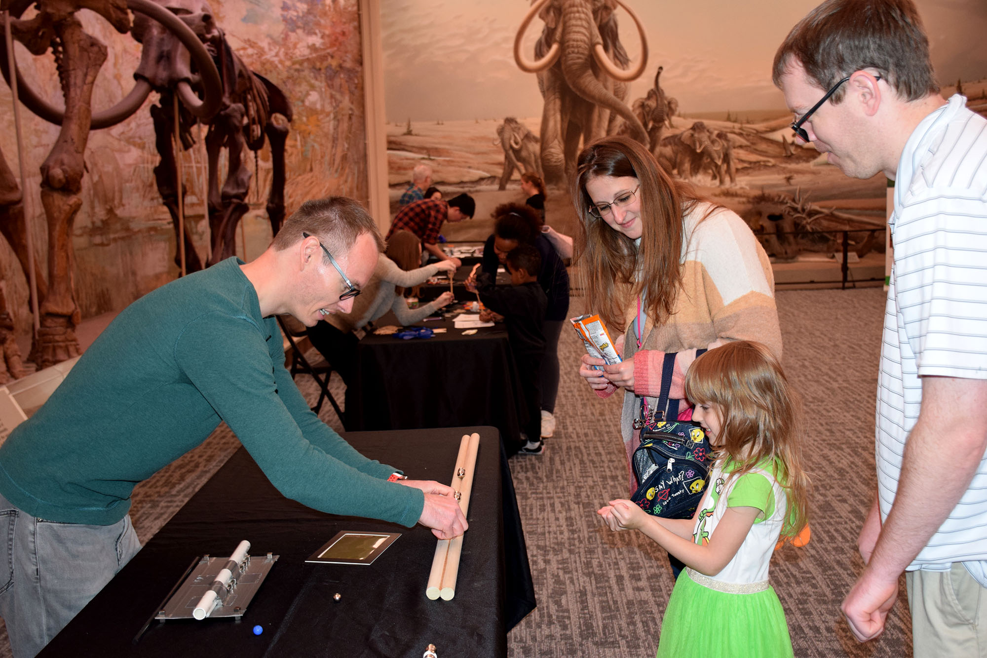 Physicist Robert Streubel shares a magnetics activity with a Nebraska family