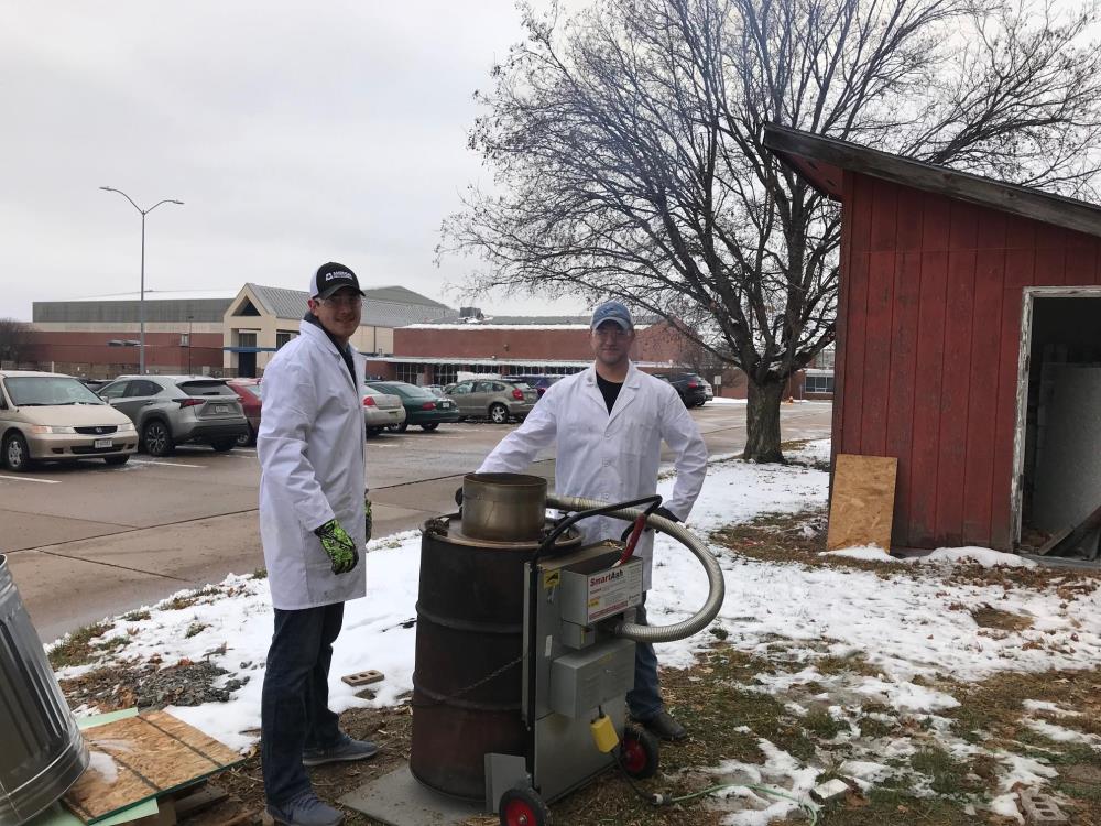 University of Nebraska at Kearney students Cam Geiger and Treyten Ruhl use an ashing cyclonic furnace to convert corn to ash, in a research project with Construction Management Assistant Professor Mahmoud Shakouri. The project investigates using corn waste as material for cement, and was funded by Nebraska EPSCoR.