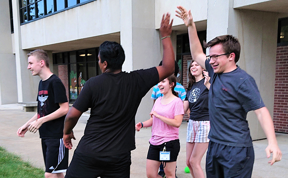 YNS campers celebrate an achievement with a group high-five